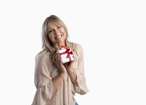 Female holding birthday or Christmas presents wrapped and tied with ribbon.  She is smiling and on a white background.