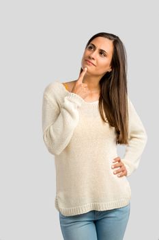 Studio shot of a beautiful young woman with a thinling expression