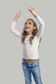 Cute little girl playing with soap bubbles