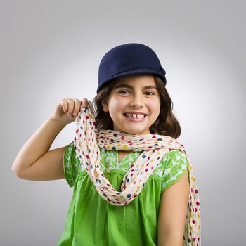 Studio portrait of a beautiful little girl smiling