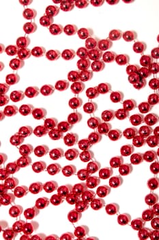 Decorative christmas red beads isolated on a white background.