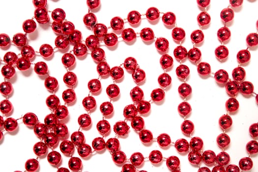 Decorative christmas red beads isolated on a white background.