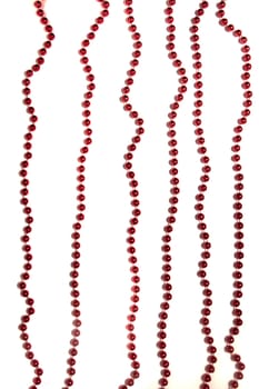 Decorative christmas red beads isolated on a white background.