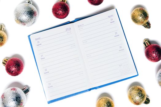 agenda surrounded with xmas balls isolated on a white background.