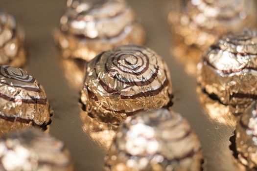 Box of sweet round chocolate candies for christmas celebrations.
