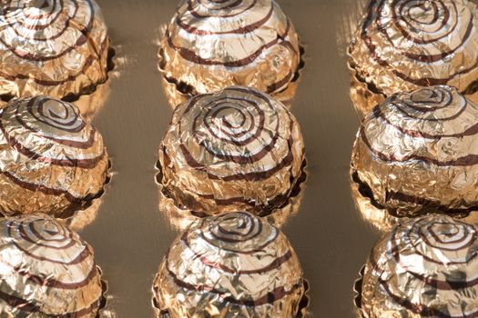 Box of sweet round chocolate candies for christmas celebrations.