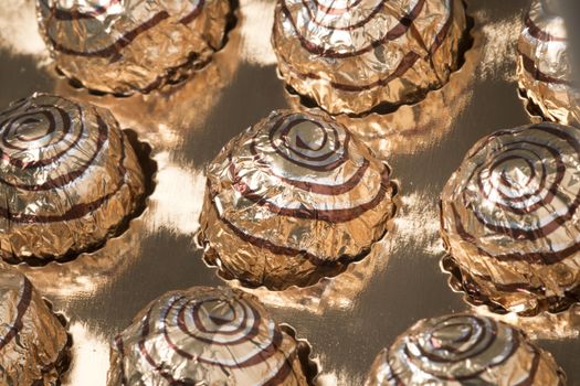 Box of sweet round chocolate candies for christmas celebrations.