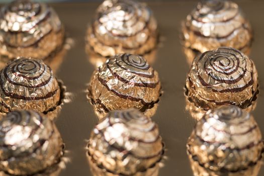 Box of sweet round chocolate candies for christmas celebrations.