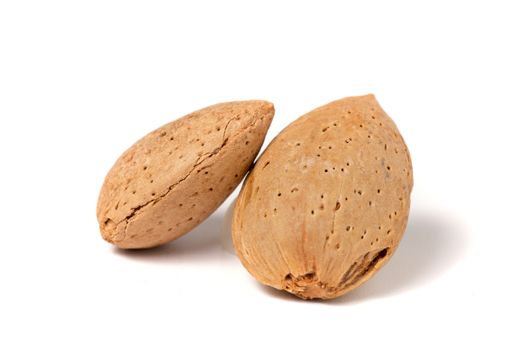 Two sweet almonds isolated on a white background.