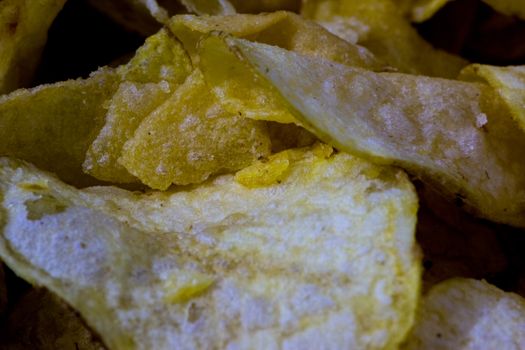 small pieces of the salty and fried potato chips