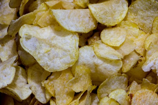 small pieces of the salty and fried potato chips