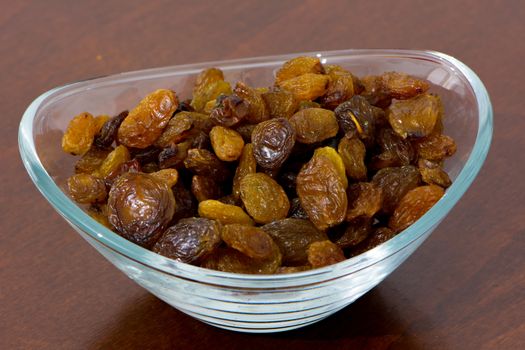 healthy and energy rich dry raisins in the bowl on the kitchen table