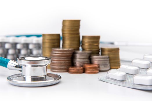 coin stack growing business with medical instruments stethoscope, Saving money concept.