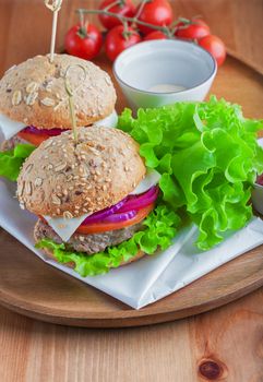 Cheeseburger with salad, onion, tomato and fresh bread