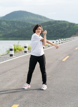 Fitness and lifestyle concept - Young asian woman short hair doing exercising outdoor