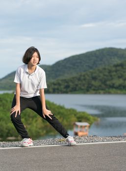 Fitness and lifestyle concept - Young asian woman short hair doing exercising outdoor