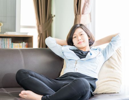 Close up beautiful young asian woman short hair relaxation by side the window in living room at home