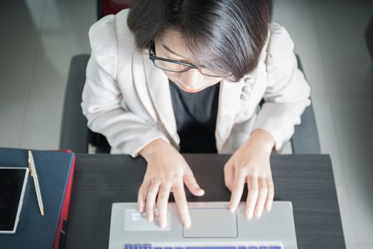 Young asian woman short hair in smart casual wear working on laptop in home office