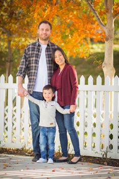 Outdoor Portrait of Mixed Race Chinese and Caucasian Parents and Child.