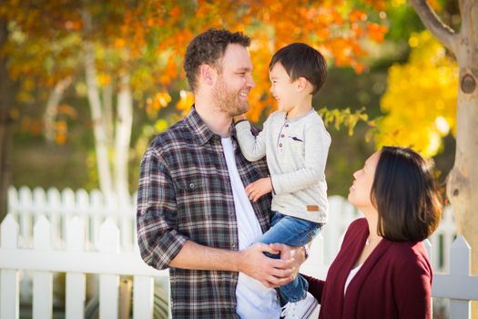 Outdoor Portrait of Mixed Race Chinese and Caucasian Parents and Child.