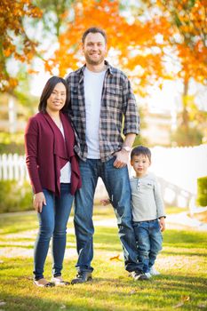 Outdoor Portrait of Mixed Race Chinese and Caucasian Parents and Child.