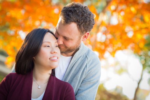 Outdoor Fall Portrait of Chinese and Caucasian Young Adult Couple.