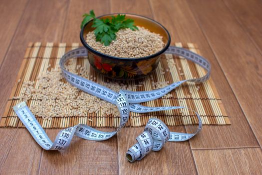 Wooden ware of folk art with pearl barley and centimeter, the Russian Khokhloma