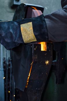 Industrial grinder showers sparks while working with metal.