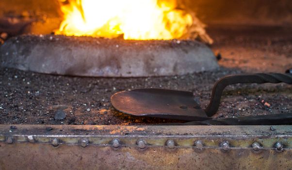 Blacksmith at work, hit with a hammer by a hot metal on the anvil.
