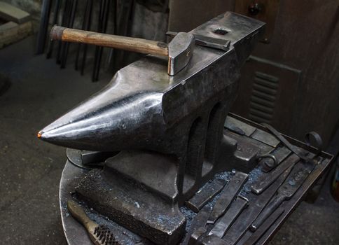 Blacksmith at work, hit with a hammer by a hot metal on the anvil.