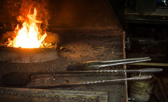Blacksmith at work, hit with a hammer by a hot metal on the anvil.
