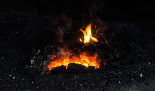 Blacksmith at work, hit with a hammer by a hot metal on the anvil.