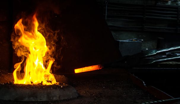 Blacksmith at work, hit with a hammer by a hot metal on the anvil.