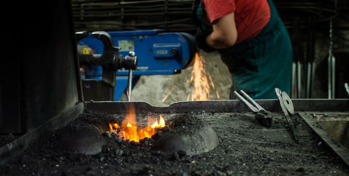 Blacksmith at work, hit with a hammer by a hot metal on the anvil.