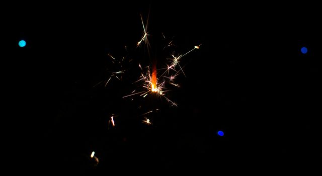 Sparkler and Christmas lights as an ideal background
