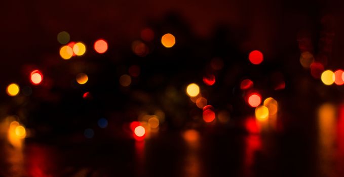 Deliberately blurred Christmas color lights in the background.