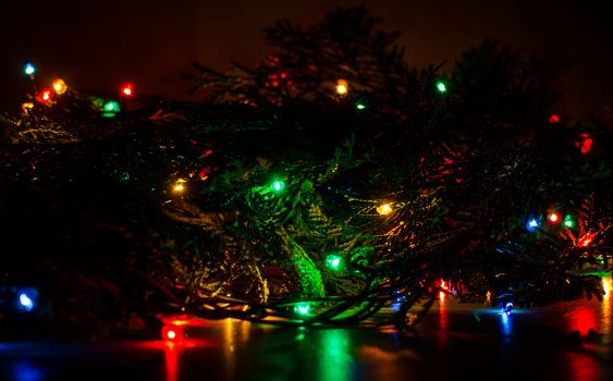 Christmas lights on a tree in different colors are classic symbol of Christmas.