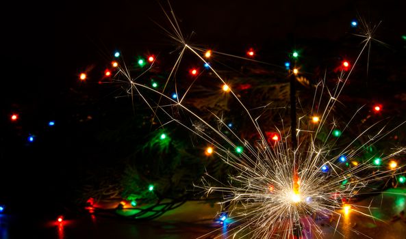 Sparkler and Christmas lights as an ideal background