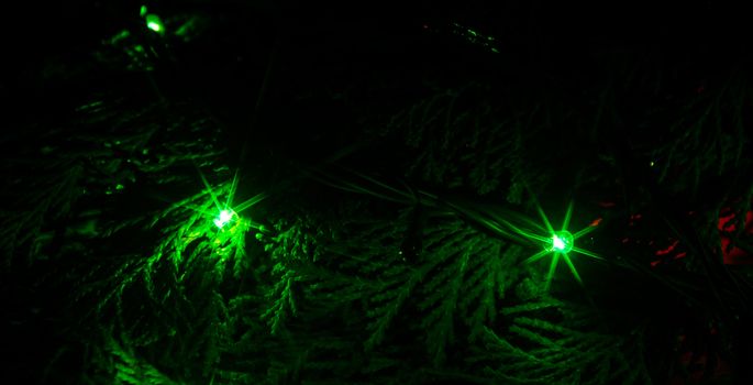Christmas lights on a tree in different colors are classic symbol of Christmas.