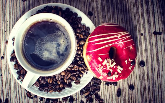 A chocolate donut with coffee for a hearty breakfast.