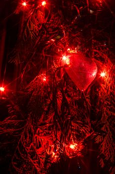 Christmas lights on a tree in different colors are classic symbol of Christmas.