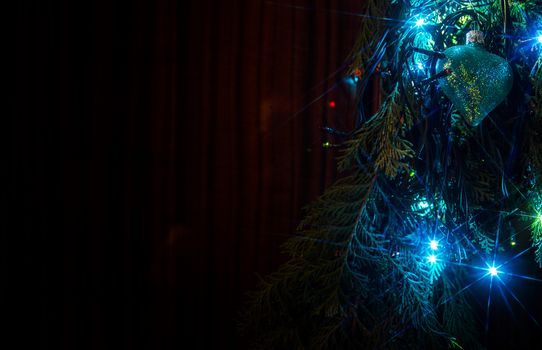 Christmas lights on a tree in different colors are classic symbol of Christmas.