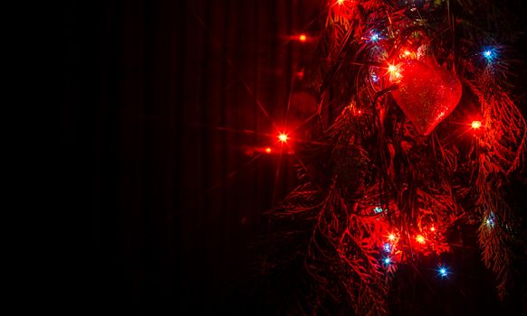 Christmas lights on a tree in different colors are classic symbol of Christmas.