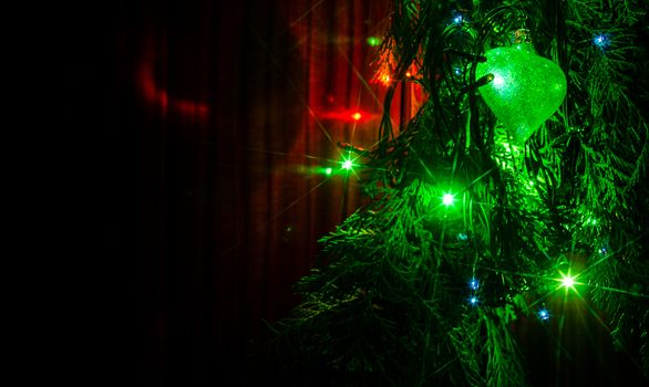 Christmas lights on a tree in different colors are classic symbol of Christmas.