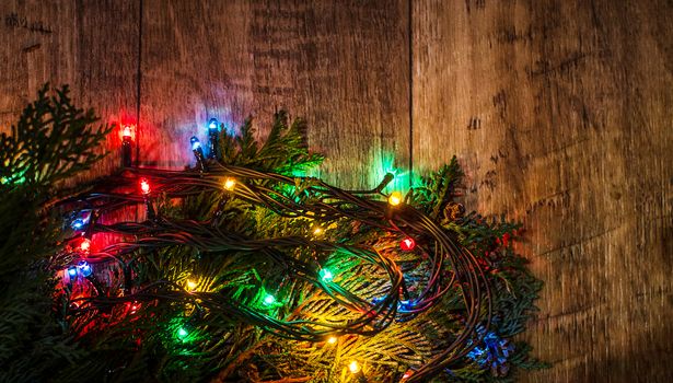 Christmas lights on a tree in different colors are classic symbol of Christmas.