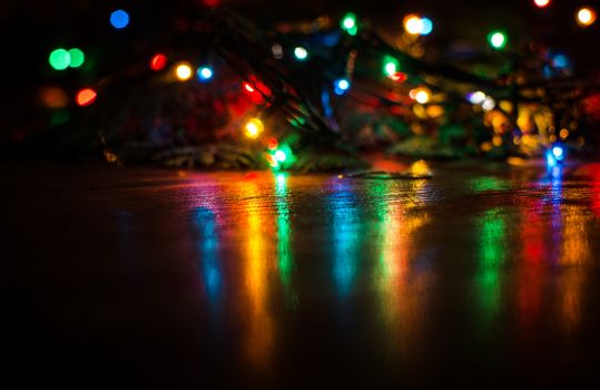 Deliberately blurred Christmas color lights in the background.