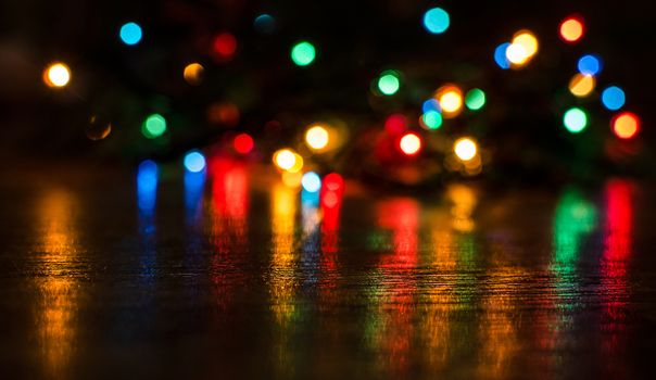 Deliberately blurred Christmas color lights in the background.