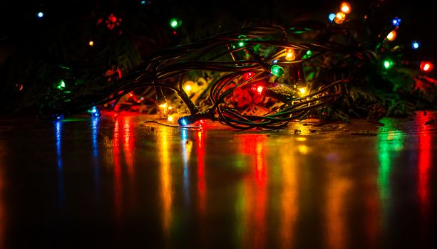 Christmas lights on a tree in different colors are classic symbol of Christmas.