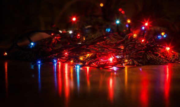Christmas lights on a tree in different colors are classic symbol of Christmas.