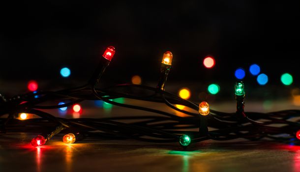 Christmas lights on a tree in different colors are classic symbol of Christmas.